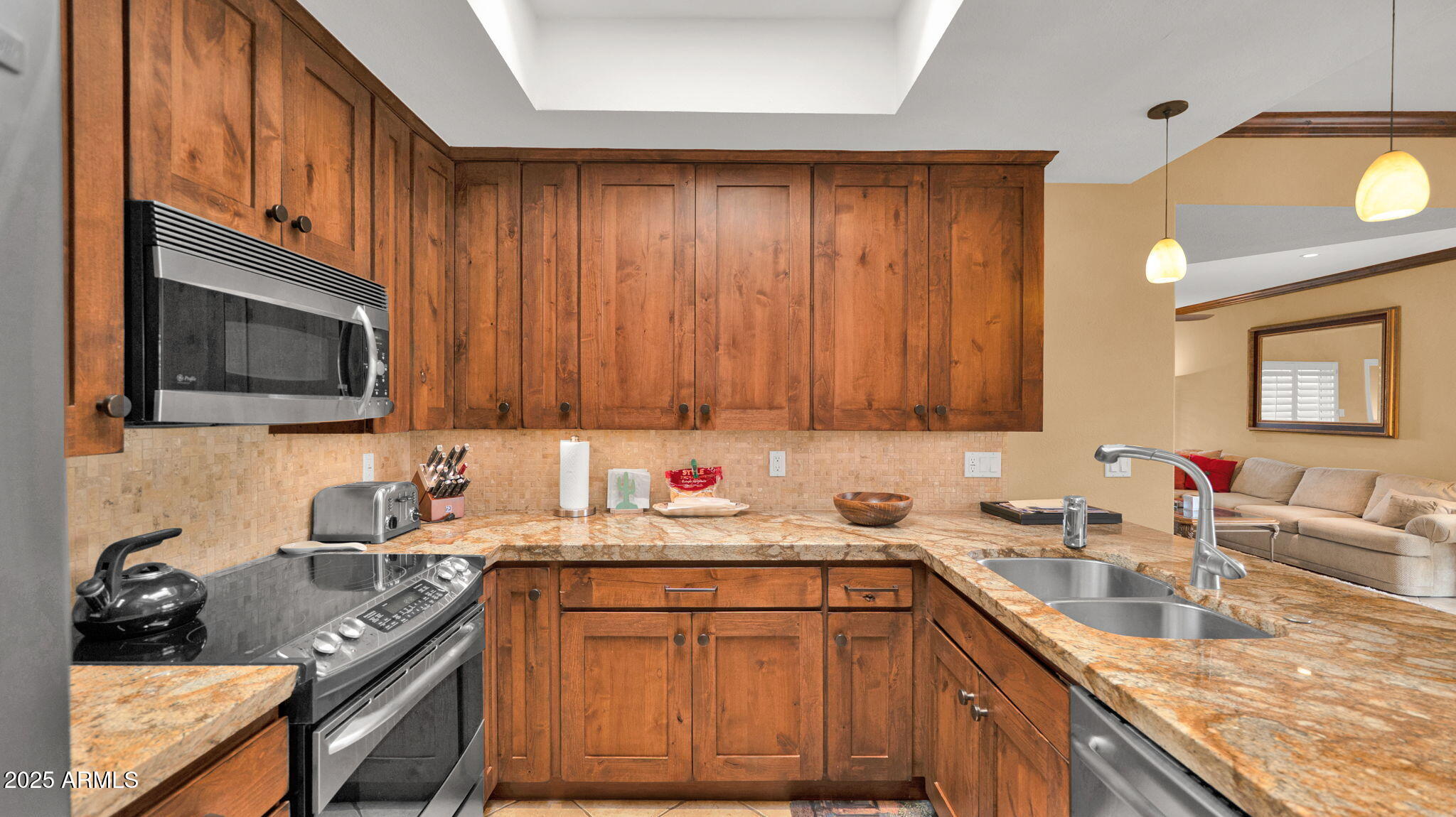 7710 East Gainey Ranch Road, Unit 113 Scottsdale, AZ 85258 - Photo 9 of 33 a kitchen with a sink stove top oven and cabinets