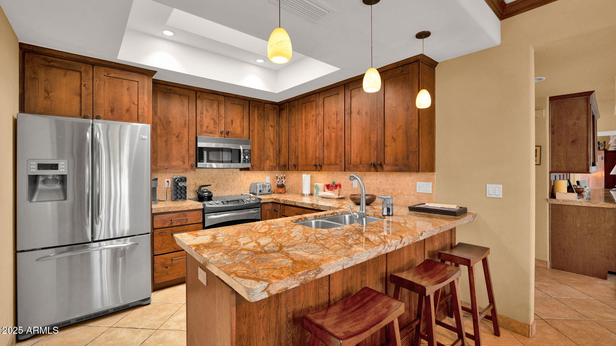 7710 East Gainey Ranch Road, Unit 113 Scottsdale, AZ 85258 - Photo 10 of 33 a kitchen with a refrigerator a stove a sink and a refrigerator