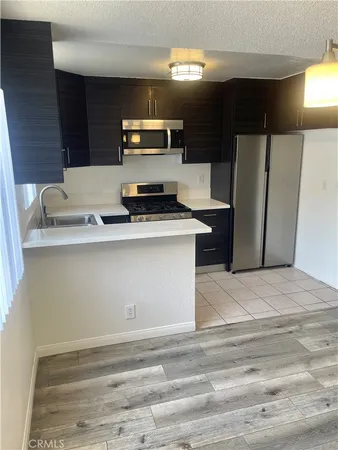 a kitchen with a refrigerator and a sink