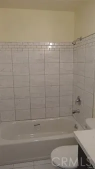 a bathroom with a toilet and a bathtub