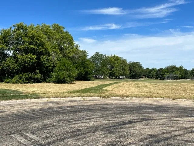 a view of a yard next to a lake