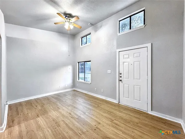 wooden floor in an empty room with a window
