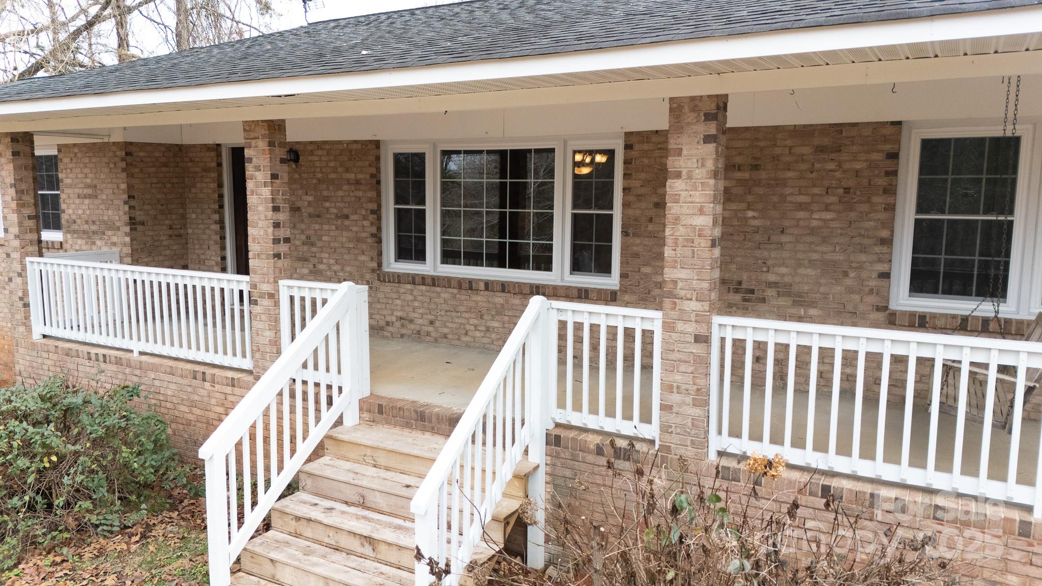 1626 Camp Creek Road Lancaster, SC 29720 - Photo 4 of 29 a view of a brick house with wooden floor and fence