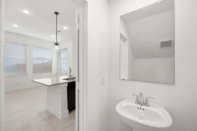 a bathroom with a sink and a mirror