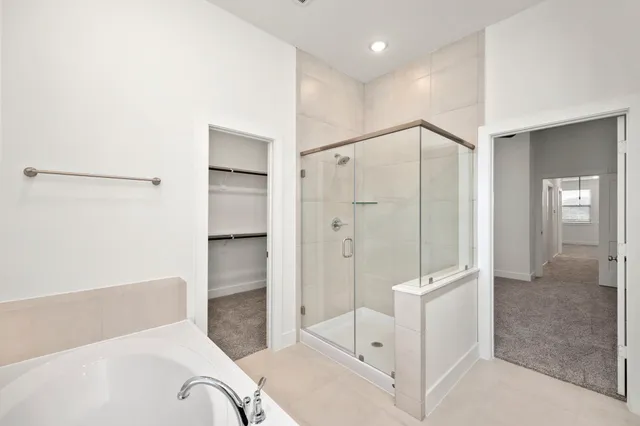 a spacious bathroom with a shower and a tub