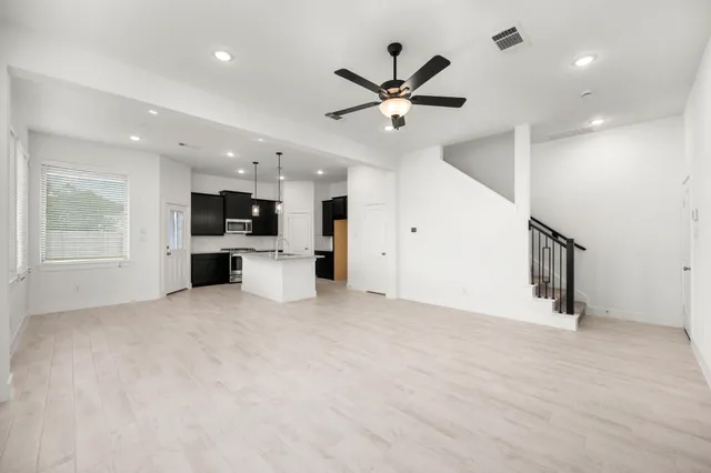 a view of a kitchen with a sink and a refrigerator