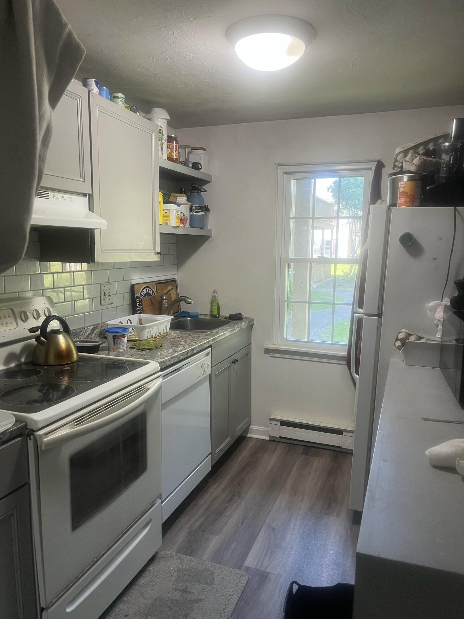 1029 Iyannough Road, Unit B BLDG 8 Hyannis, MA 02601 - Photo 1 of 14 a kitchen with a stove a sink and a microwave