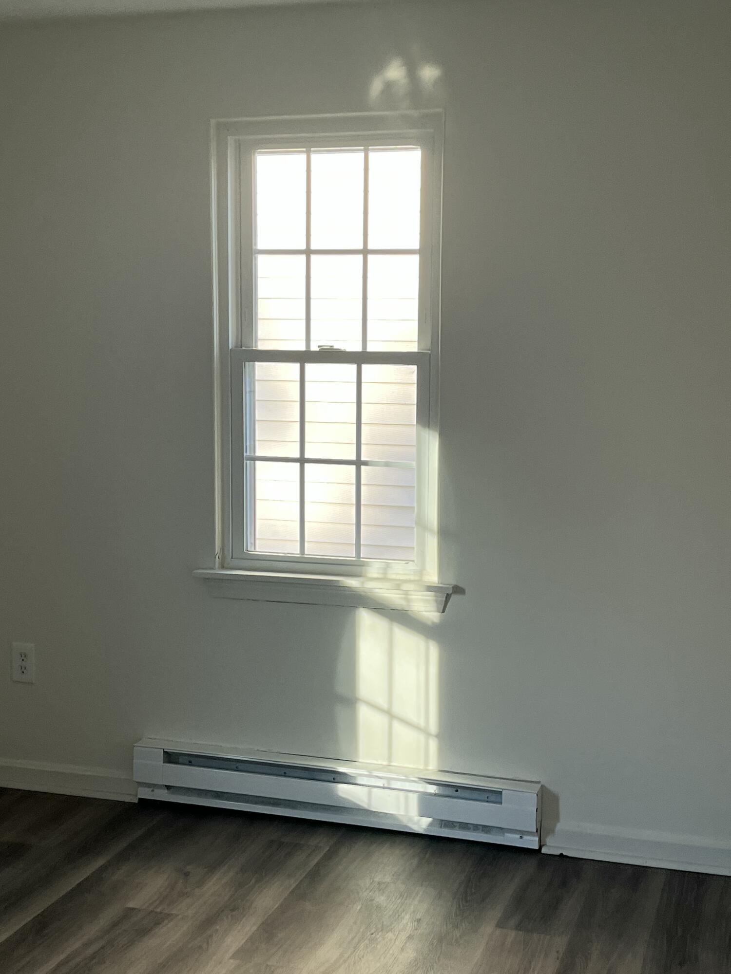 1029 Iyannough Road, Unit B BLDG 8 Hyannis, MA 02601 - Photo 11 of 13 an empty room with wooden floor and windows