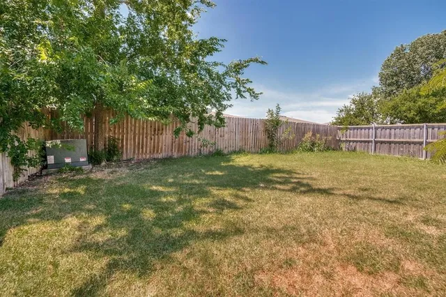a kitchen with a refrigerator sink and cabinets