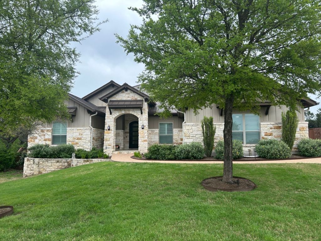 9901 Lenape Cove Austin, TX 78736 - Photo 1 of 1 a front view of a house with a garden and trees