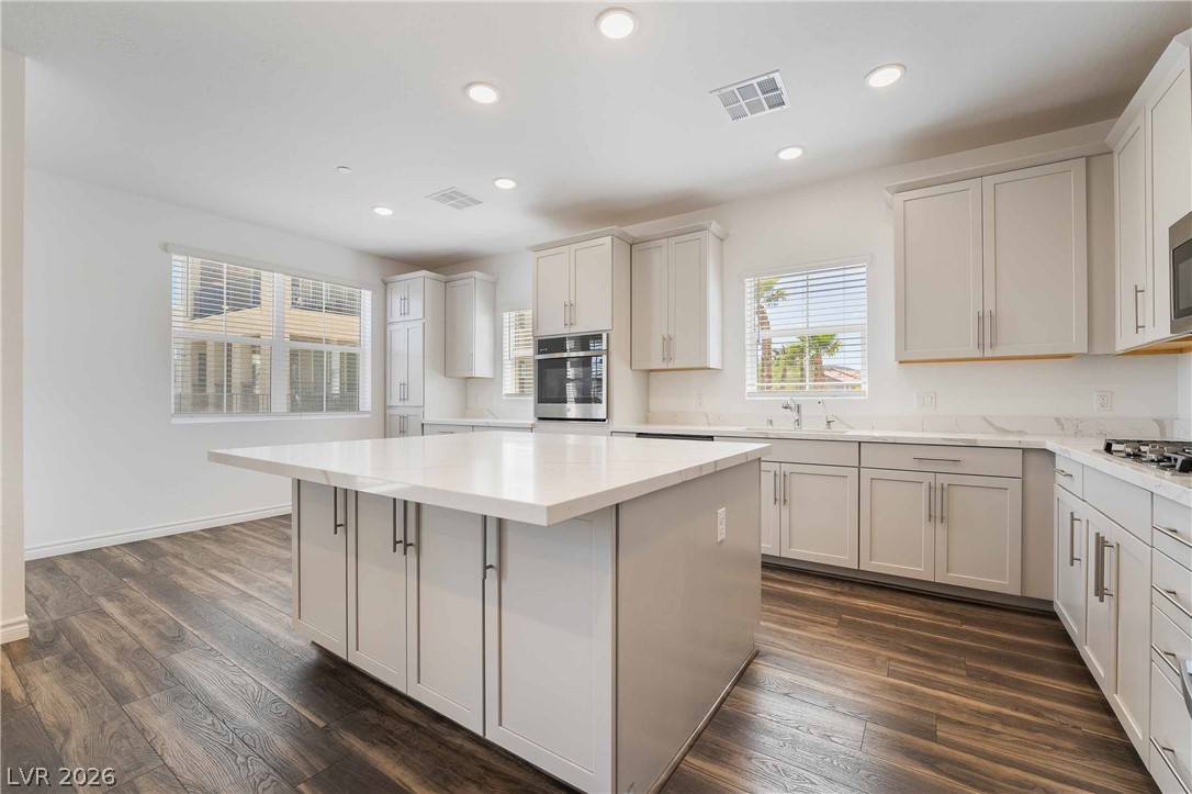 2555 Hampton Road, Unit 10202 Henderson, NV 89052 - Photo 9 of 35 Gleaming stone countertops and a spacious central island anchor this modern culinary space.