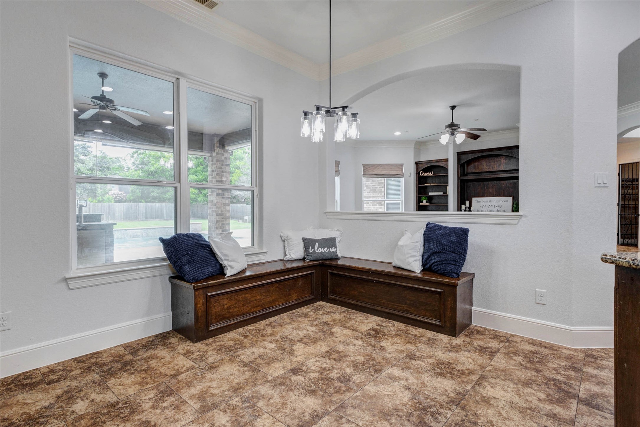 5327 Whitmore Fulshear, TX 77441 - Photo 15 of 50 The sunny breakfast nook features a charming built-in bench with hidden storage, providing the perfect spot to enjoy your morning coffee while overlooking the backyard.