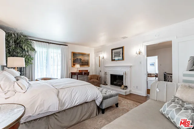 a spacious bedroom with a bed and a fireplace