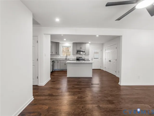 a view of kitchen view wooden floor and a window