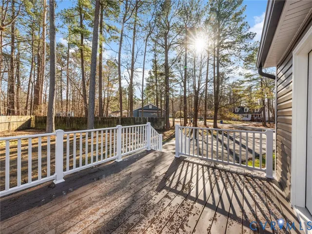 a view of a wooden balcony with wooden floor and fence