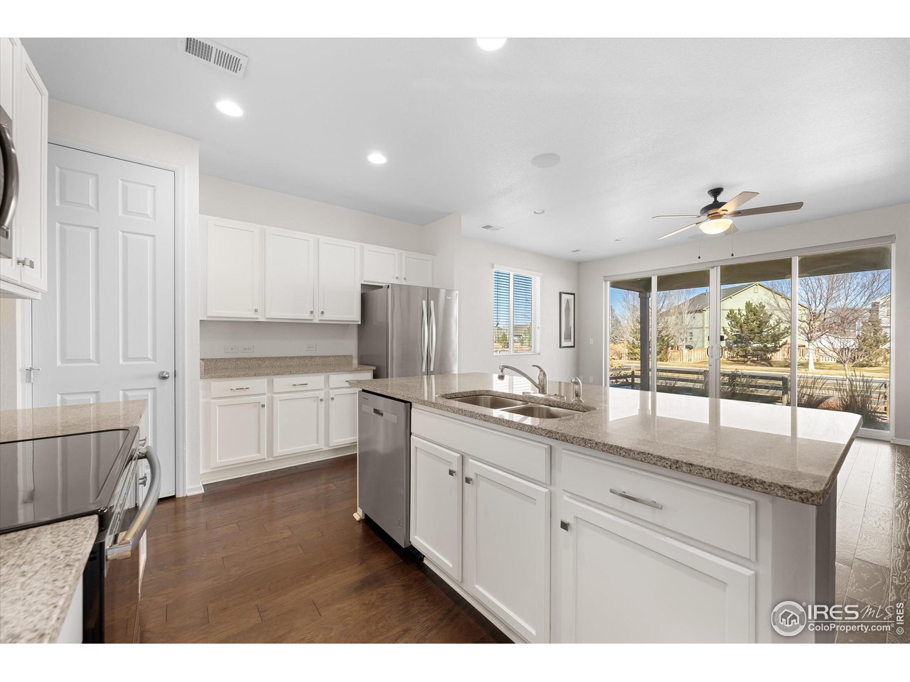 1604 Sorenson Drive Windsor, CO 80550 - Photo 12 of 32 a kitchen with stainless steel appliances granite countertop a sink and cabinets
