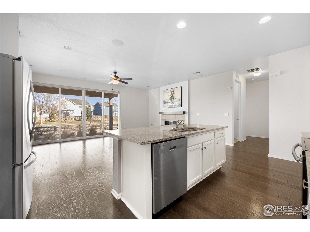 1604 Sorenson Drive Windsor, CO 80550 - Photo 13 of 32 a open kitchen with granite countertop a view of living room