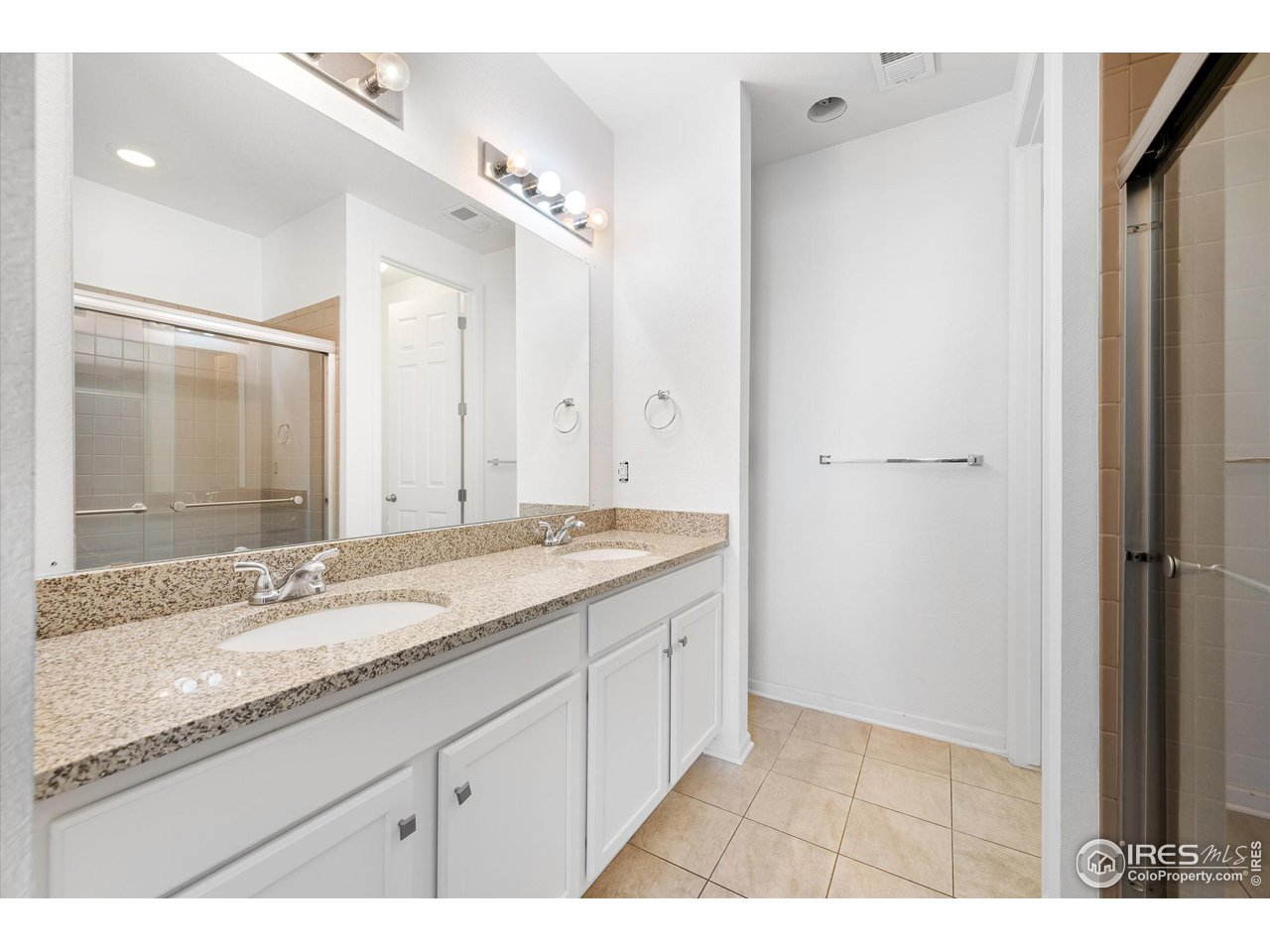 1604 Sorenson Drive Windsor, CO 80550 - Photo 28 of 32 a bathroom with a granite countertop double vanity sink and mirror
