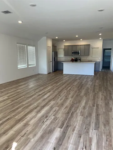 a large kitchen with stainless steel appliances granite countertop a stove and a sink