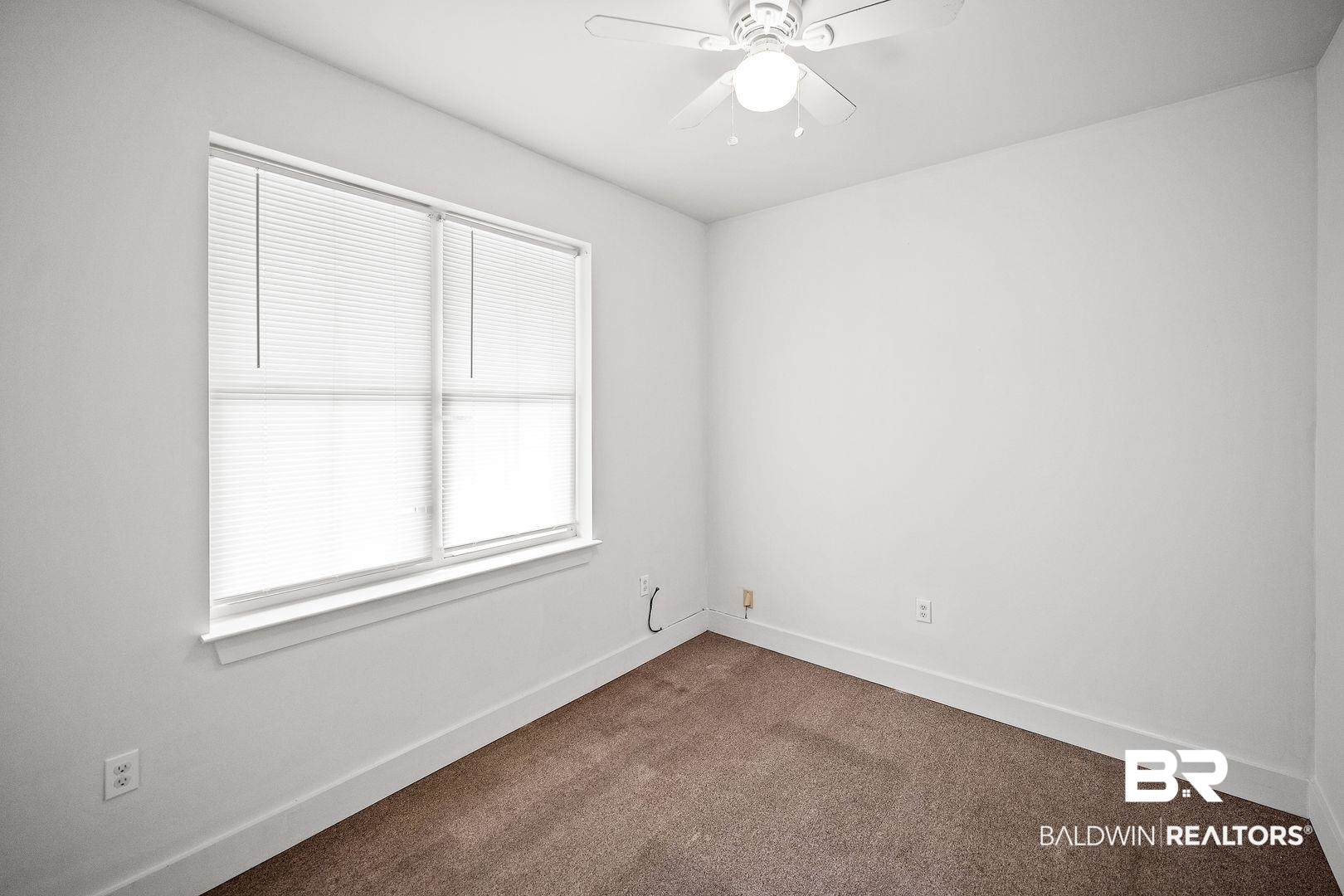 635 East Azalea Avenue Foley, AL 36535 - Photo 5 of 18 Neutral wall paint and brown carpeting