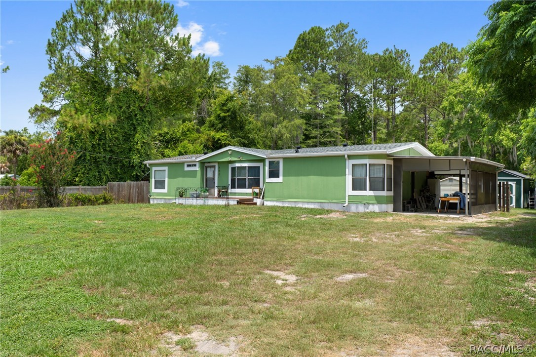 7927 West Cyprian Court Homosassa, FL 34448 - Photo 3 of 40 a front view of a house with a garden