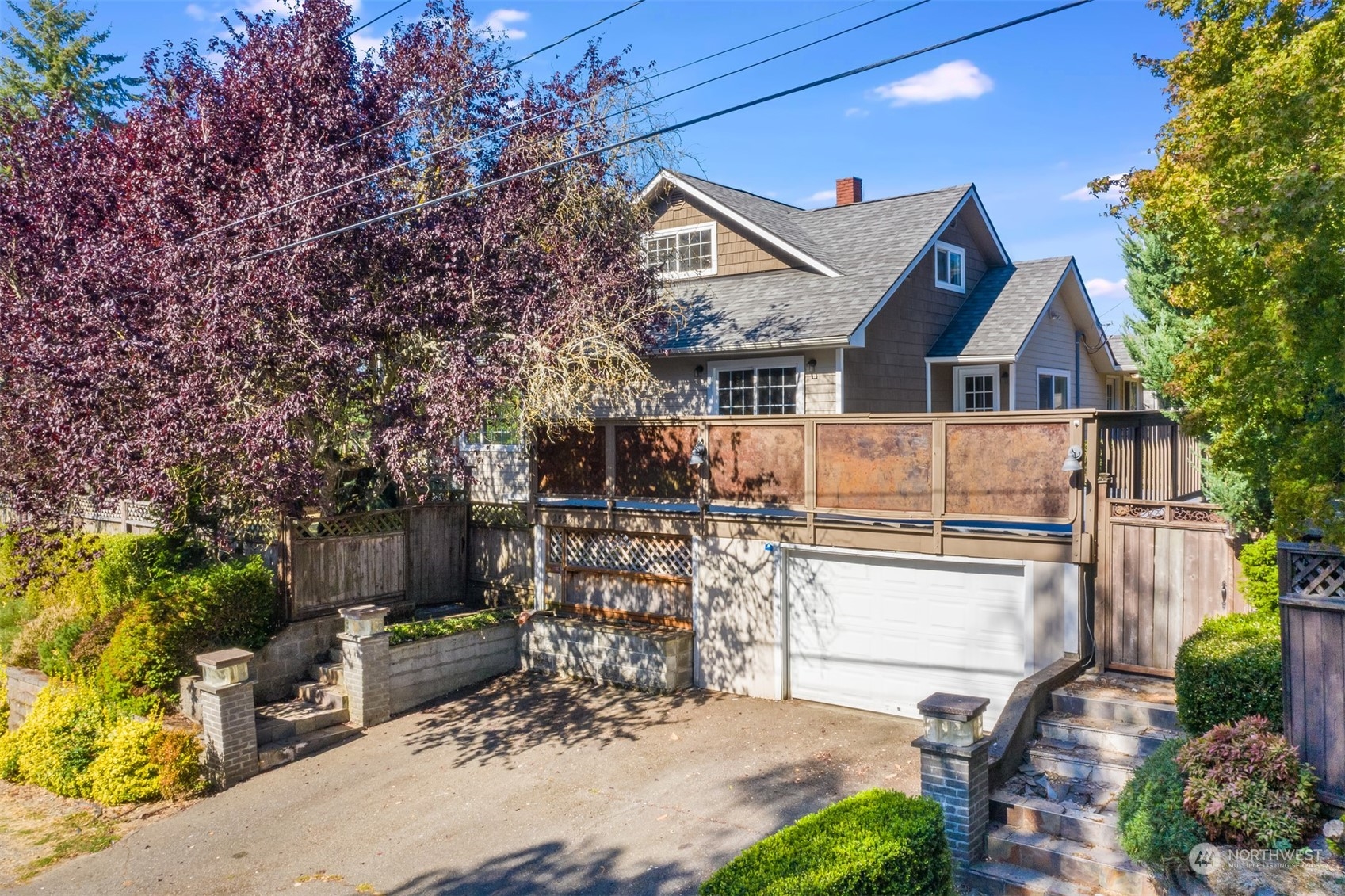 a view of a patio with table and chairs potted plants and large tree