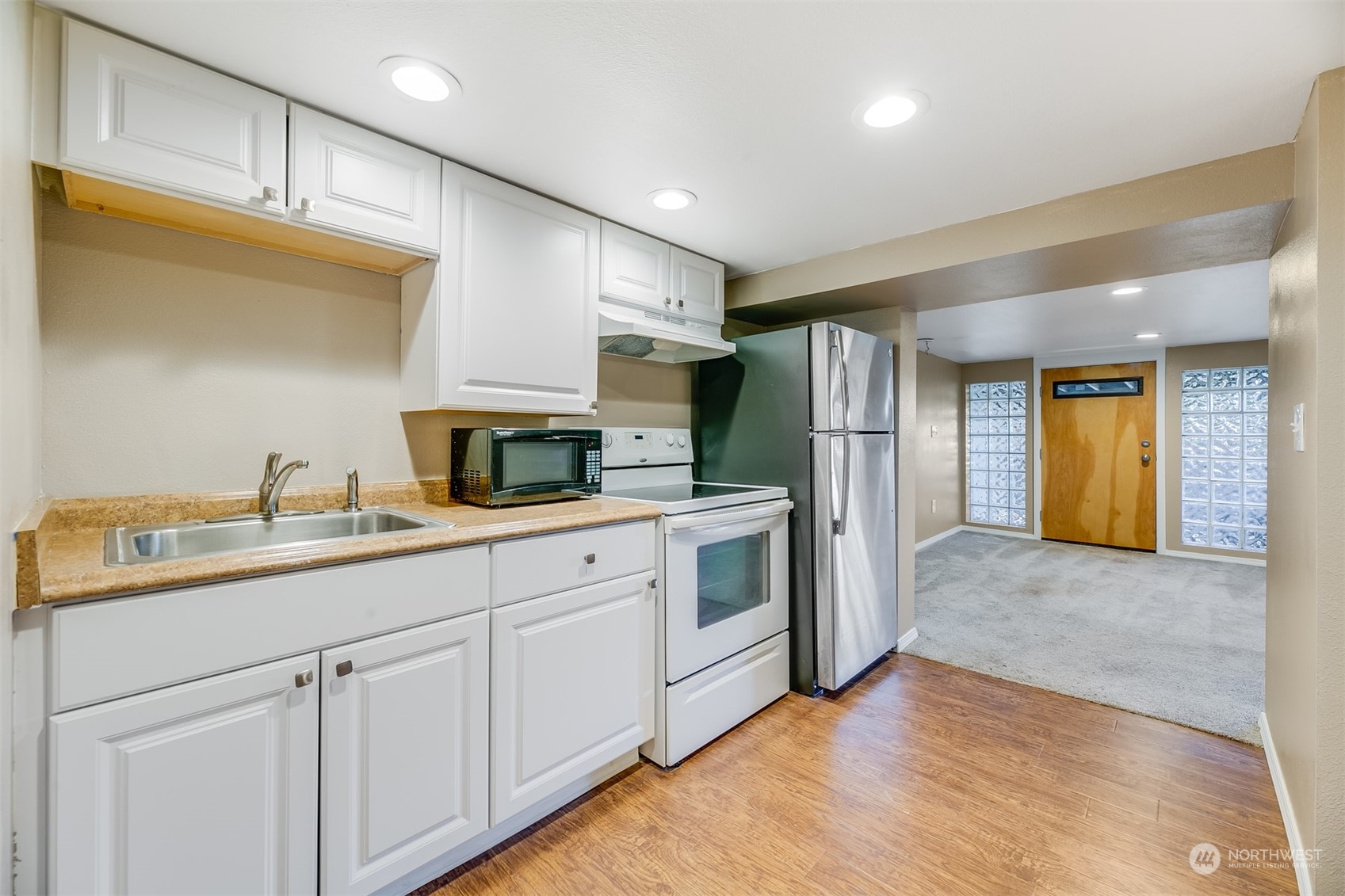 2528 Southwest 112th Street Seattle, WA 98146 - Photo 11 of 33 a kitchen with refrigerator and cabinets