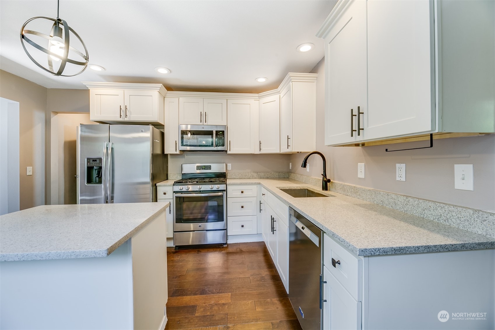 2528 Southwest 112th Street Seattle, WA 98146 - Photo 2 of 33 a kitchen with kitchen island a sink stainless steel appliances and cabinets