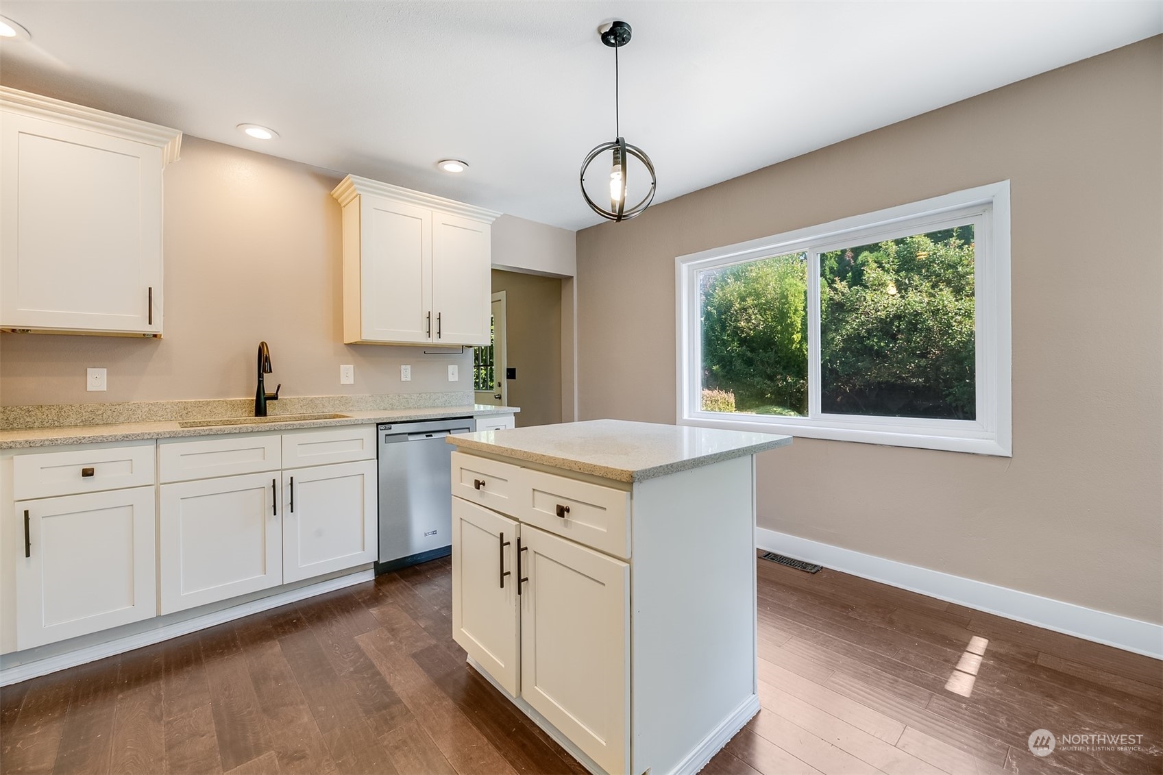 2528 Southwest 112th Street Seattle, WA 98146 - Photo 5 of 33 a kitchen with white cabinets stainless steel appliances and a large window