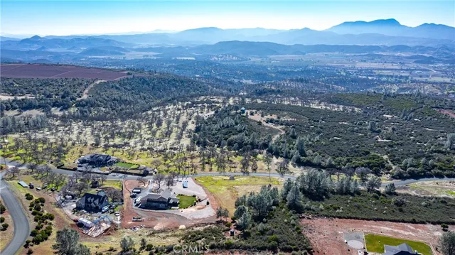 a view of a lush green hillside and houses