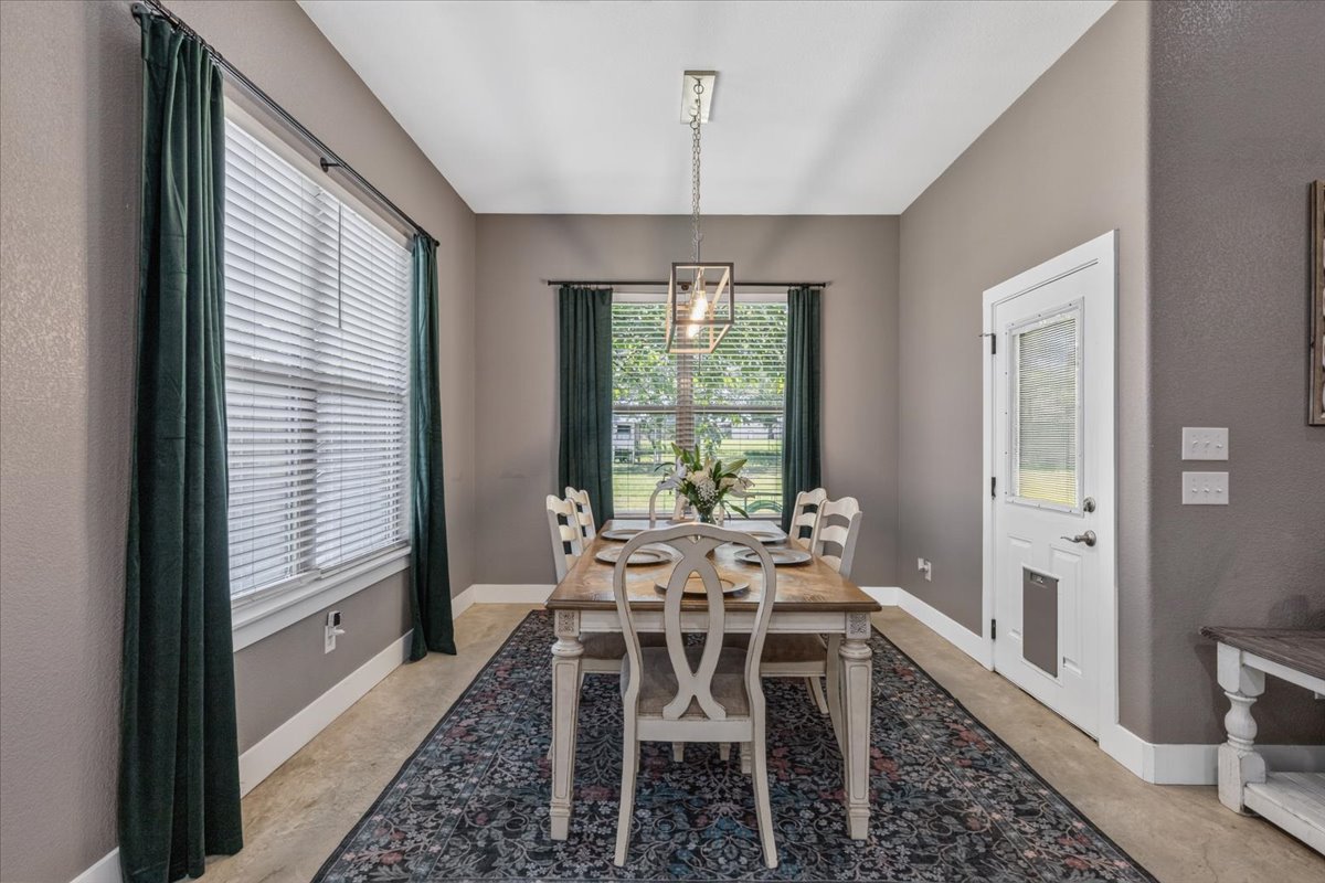 145 Cardinal Loop Paige, TX 78659 - Photo 18 of 40 A graceful dining room bathed in natural light, perfect for intimate gatherings.