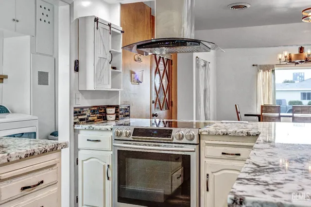 a kitchen with stainless steel appliances a stove a sink and a refrigerator