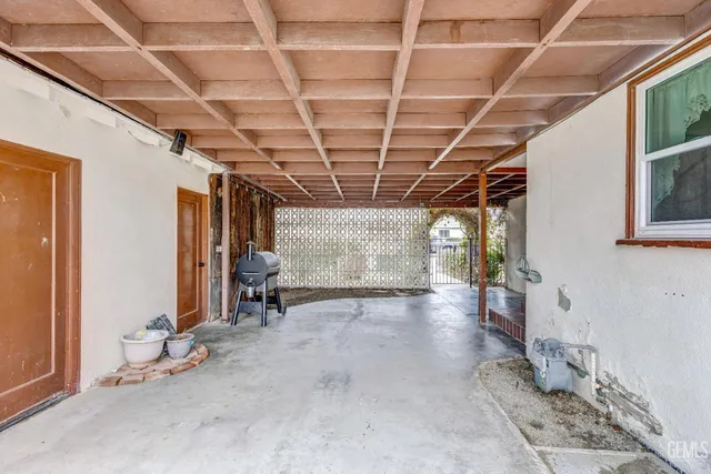 a view of empty room with wooden floor and windows