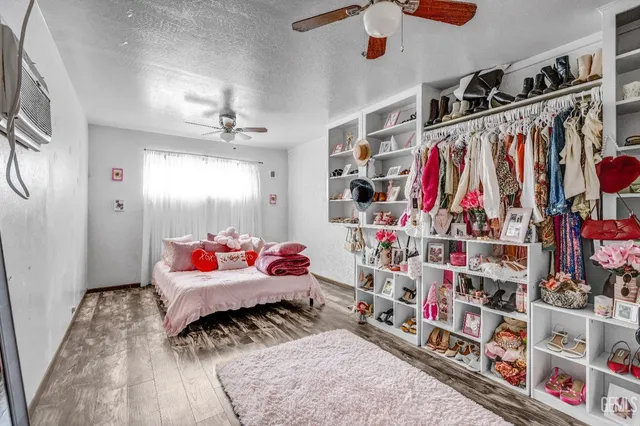 a view of walk in closet with clothes and shoes