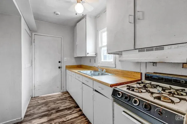 a kitchen with a stove and a sink
