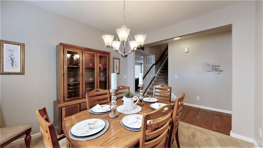 3012 Fallondale Road Waxhaw, NC 28173 - Photo 8 of 47 a view of a dining room with furniture wooden floor and chandelier