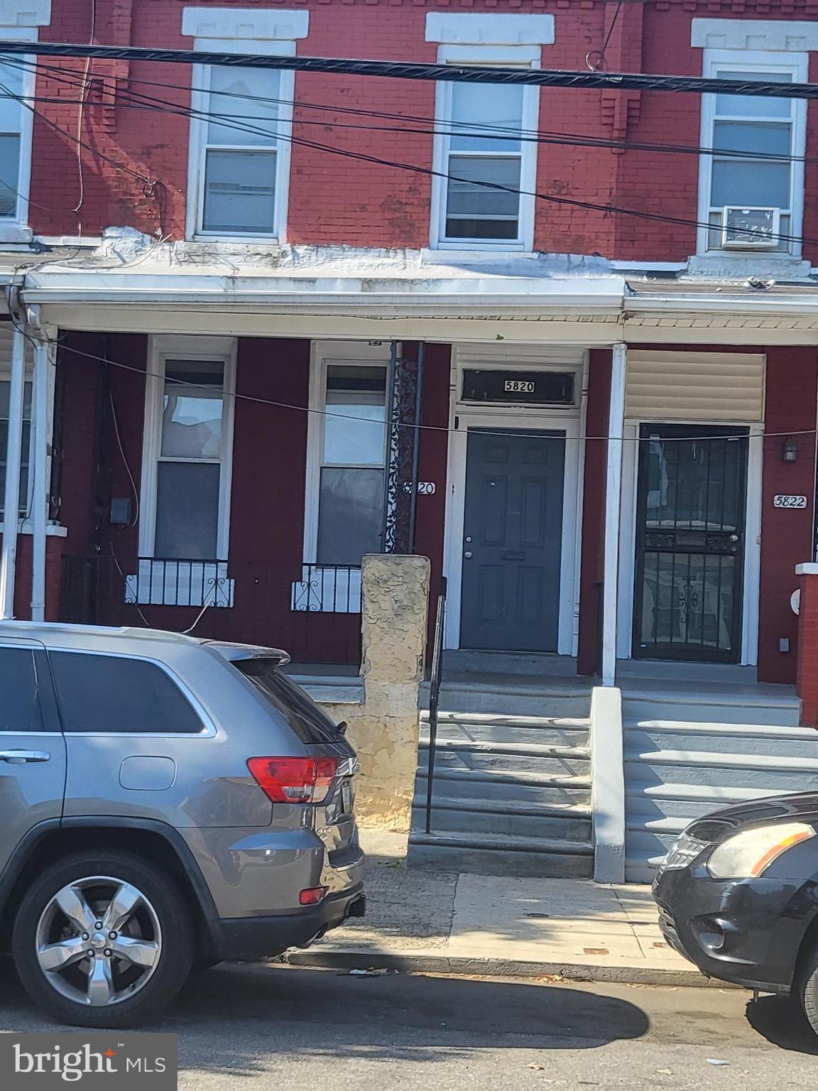 5820 Arch Street, Unit 1 Philadelphia, PA 19139 - Photo 3 of 9 a front view of a building with car parked