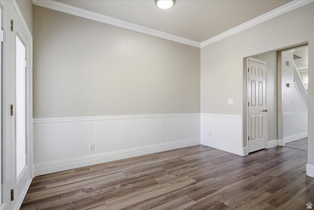 4496 West 11800 South South Jordan, UT 84009 - Photo 17 of 33 Unfurnished room with ornamental molding, dark wood finished floors, and a wainscoted wall