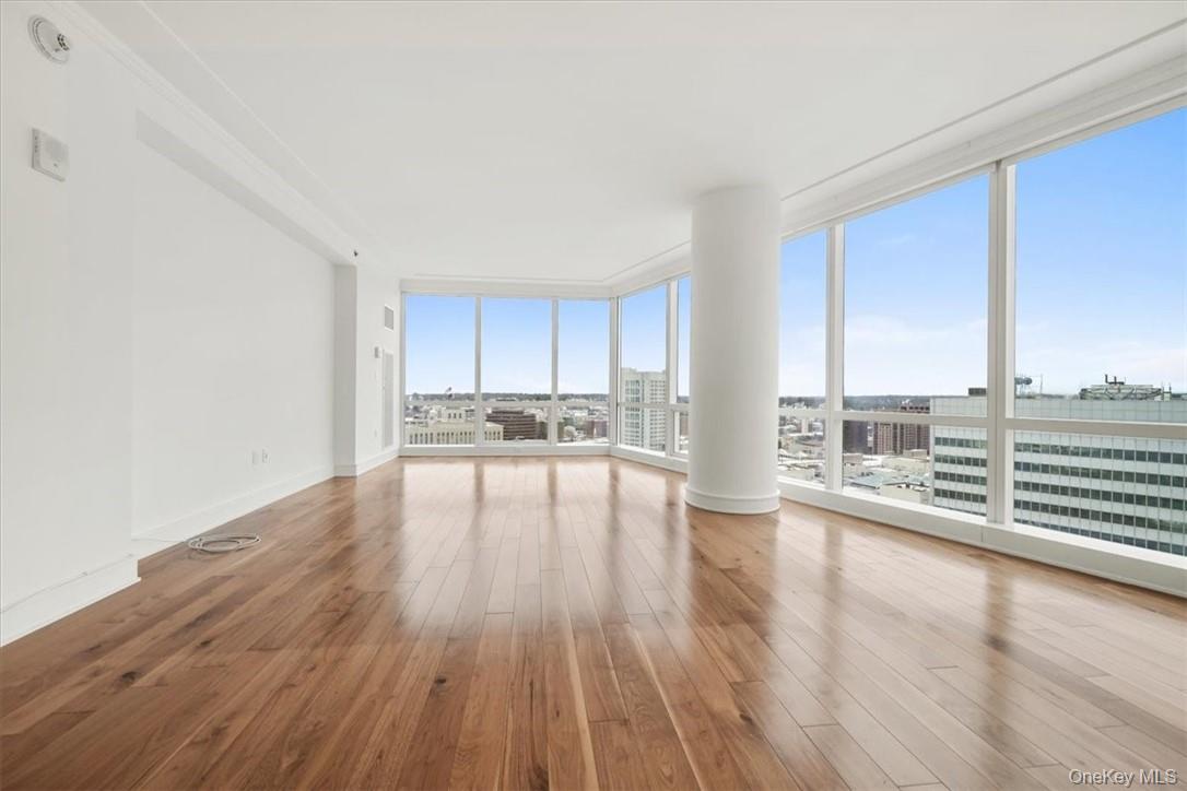 5 Renaissance Square, Unit 21E White Plains, NY 10601 - Photo 11 of 34 a view of open kitchen with wooden floor and electronic appliances