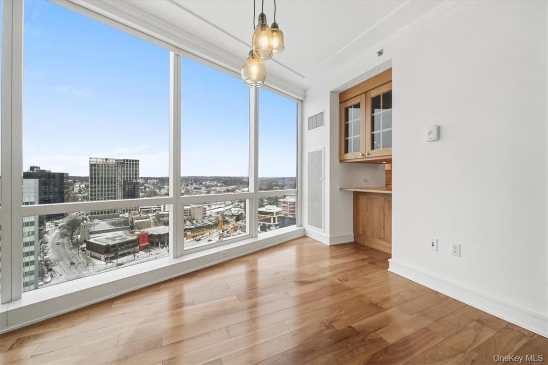 5 Renaissance Square, Unit 21E White Plains, NY 10601 - Photo 13 of 34 a living room with furniture and a floor to ceiling window