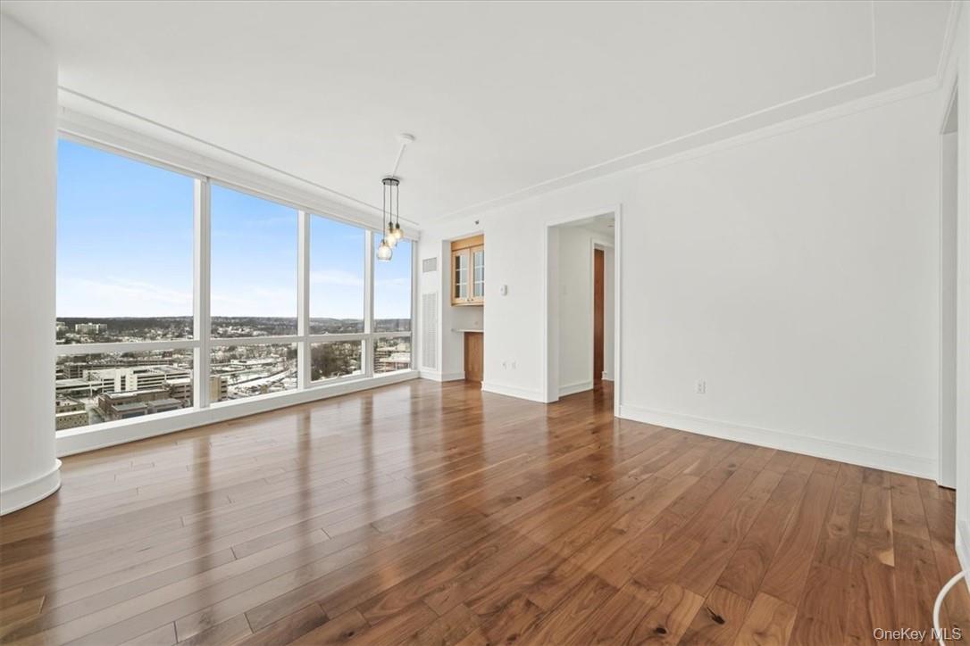 5 Renaissance Square, Unit 21E White Plains, NY 10601 - Photo 14 of 34 wooden floor in an empty room with a window