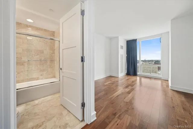 a bathroom with a tub and shower