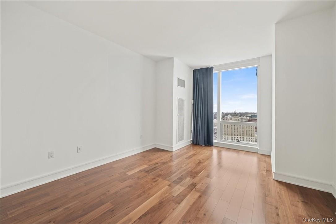 5 Renaissance Square, Unit 21E White Plains, NY 10601 - Photo 21 of 34 a view of a room with wooden floor
