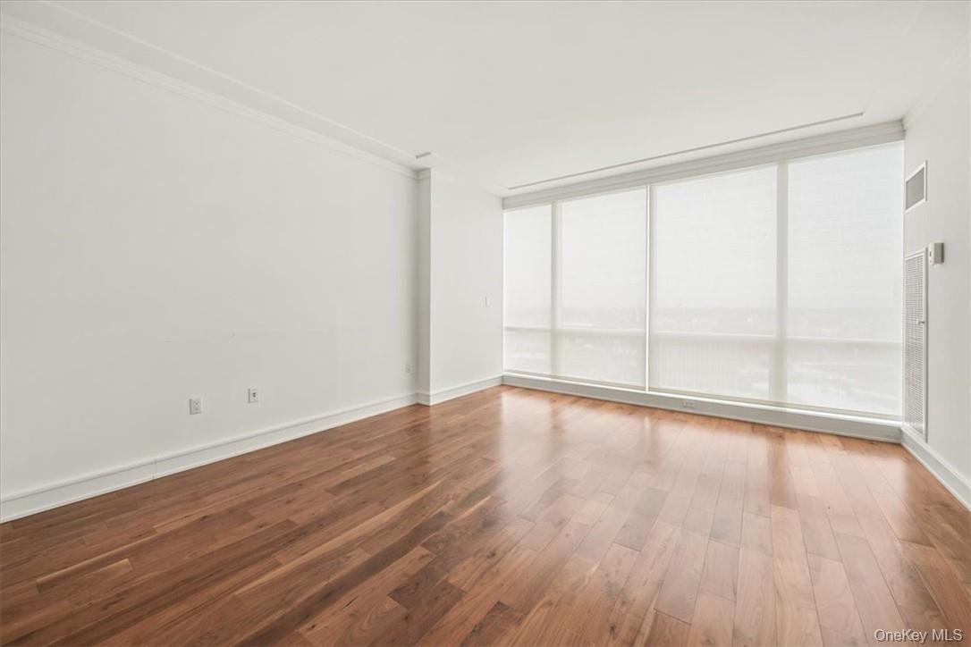5 Renaissance Square, Unit 21E White Plains, NY 10601 - Photo 25 of 34 wooden floor in an empty room with a window