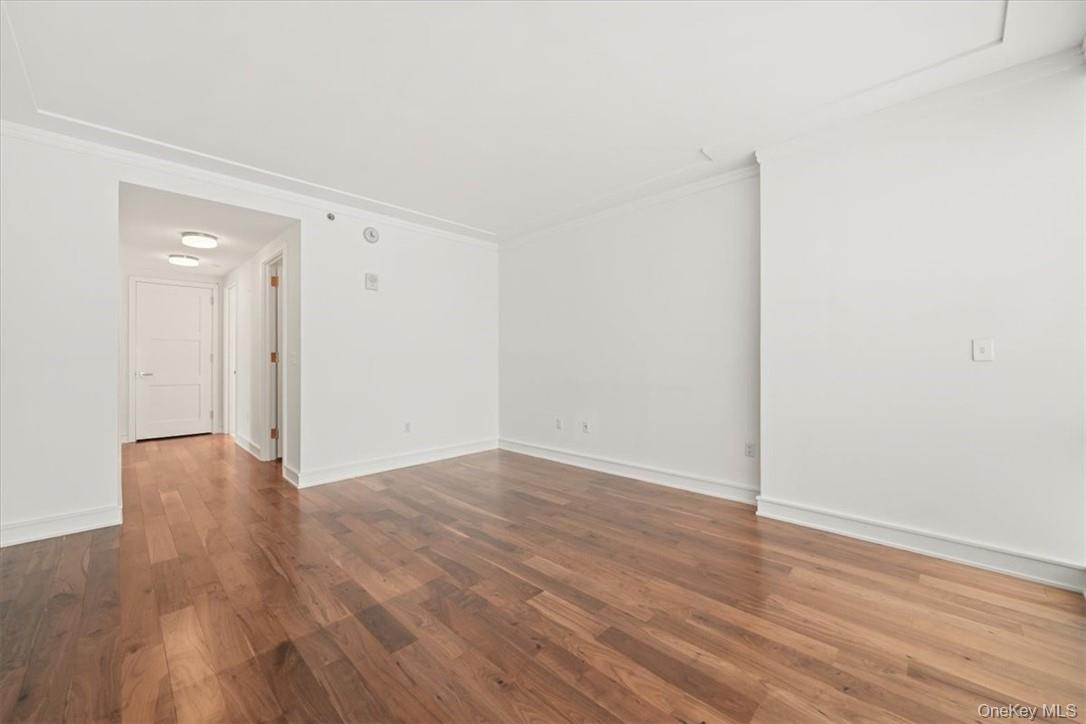 5 Renaissance Square, Unit 21E White Plains, NY 10601 - Photo 27 of 34 a view of an empty room with wooden floor
