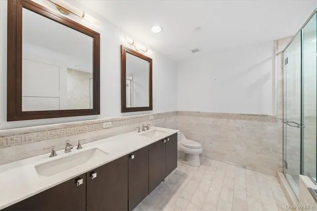 a bathroom with a double vanity sink mirror and double