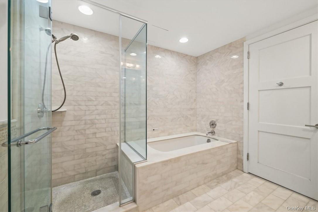 5 Renaissance Square, Unit 21E White Plains, NY 10601 - Photo 29 of 34 a bathroom with a bathtub and a shower