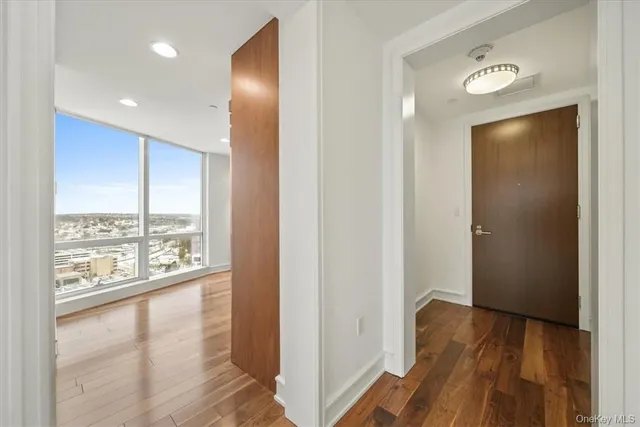 a view of hallway with wooden floor