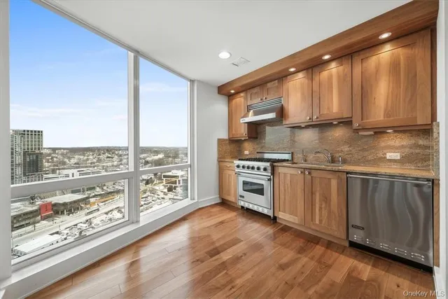 a kitchen with stainless steel appliances a stove sink and cabinets