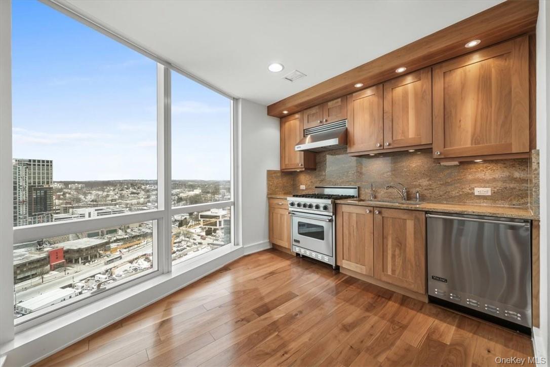5 Renaissance Square, Unit 21E White Plains, NY 10601 - Photo 5 of 34 a kitchen with stainless steel appliances a stove sink and cabinets